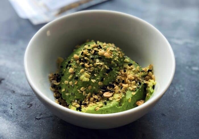 bowl with avocado topped with hemp hearts that are nutritional and have many health benefits